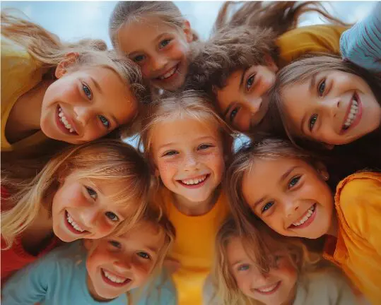 Group of happy children smiling down at the camera, celebrating healthy smiles with the Early Observation SmileClub at Align Choice Orthodontics in Everett, WA.